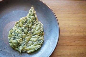 Close-up Crispy Leaves in a Dish on wooden table .Thai food,Thai style.