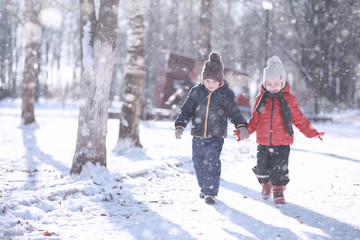 Kids walk in the park first snow