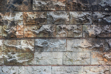 Dirty worn wall of light stone blocks