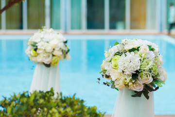 Flower bouquet at swimming  pool in wedding party for decoration.