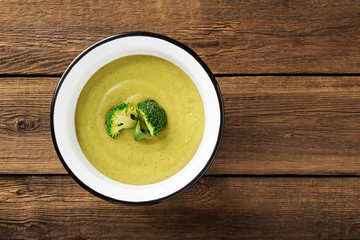 Fresh broccoli cream soup in bowl. Top view