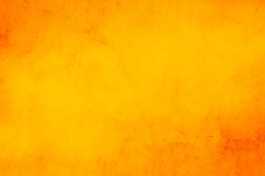 Horizontal yellow and orange grunge texture cement or concrete wall banner, blank  background