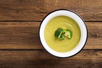 Fresh broccoli cream soup in bowl. Top view