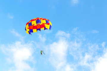 Fototapeta na wymiar Flight on a parachute behind a boat