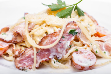 Pasta Carbonara with bacon, tomatoes and parmesan.
