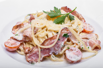 Pasta Carbonara with bacon, tomatoes and parmesan.

