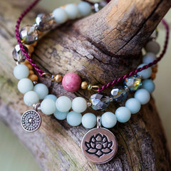 Three natural mineral stone beads bracelet on wooden background