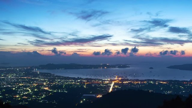 Time lapse 4K Night to Day beautiful light in the sunrise nature,dramatic sky and clouds moving in the sky over phuket city thailand