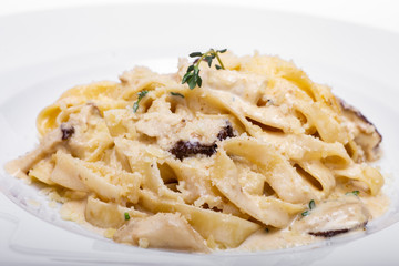 Pasta with white mushrooms in creamy sauce.
