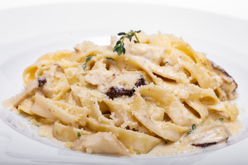 Pasta with white mushrooms in creamy sauce.
