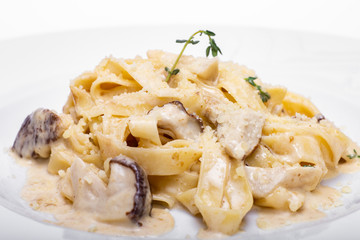 Pasta with white mushrooms in creamy sauce.
