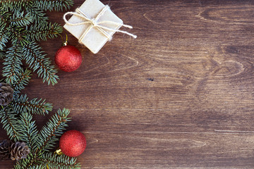 New Year's background. Spruce branches on a wooden table. Ornaments for the New Year tree. Christmas concept.