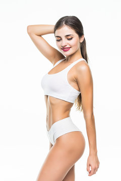 Perfect slim toned young body of the girl or fit woman isolated on white background. The fitness, diet, sports, plastic surgery and aesthetic cosmetology concept.