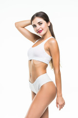 Fototapeta premium Portrait of happy beautiful fit woman in white underwear isolated on white background