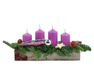 four violet advent candles with twigs isolated on white background