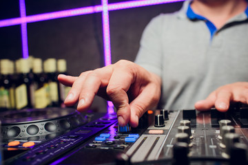 DJ remote, turntables, and hands . Night life at the club, party.