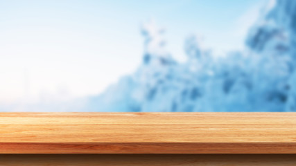 Empty wooden tabletop against Scenic view of snow monster in winter. For your product placement or montage with focus to the table top in the foreground
