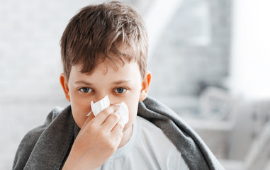 Boy get cold and blow her nose at home