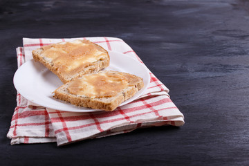sandwiches with pollock roe on a white plate, on a black background