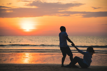 Asian lovers happy and having fun holding hands. Travel relax on the beach summer vacation.