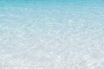 crystal clear sea water at tropical beach,reflections on surface of water