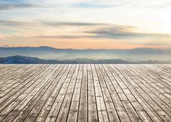 Wooden floor against Scenic view of mountain in winter. For your product placement or montage with focus to the table top in the foreground. Empty wood white shelf