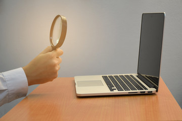 business male hand holding magnifying glass search and laptop or computer for idea creative concept - 236626002
