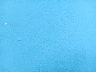 Old wall background with fissures of blue pastel.
