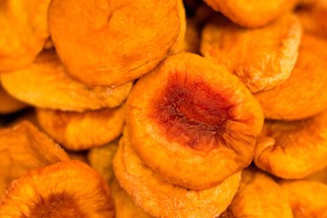 Dried sliced fruit of tasty peaches of orange shade. Very sweet and sweet fruits.