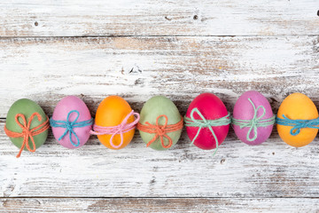 Easter eggs, frame, white wooden background, top view, copyspace