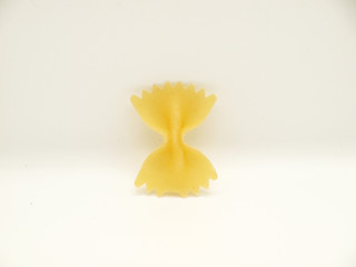 Raw bow tie pasta on white background