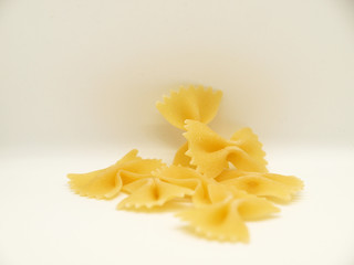 Raw bow tie pasta on white background