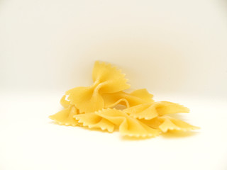 Raw bow tie pasta on white background