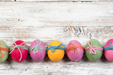 Easter eggs, frame, white wooden background, top view, copyspace