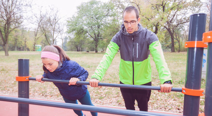 Fitness Couple Exercise In Morning At Autumn Park