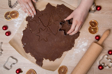 Cutting Christmas cookies, baking gingerbread men, making christmas cookie , homemade traditional  dessert.
