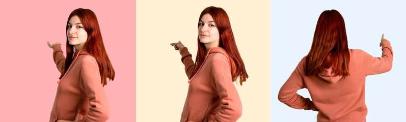 Set of Young redhead girl with pink sweatshirt pointing back with the index finger on colorful background