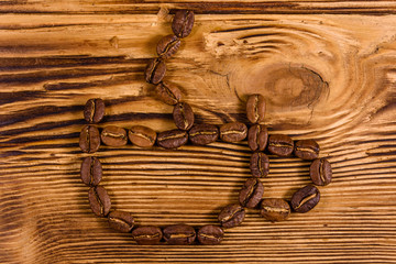 Cup shaped coffee beans on wooden table. Top view