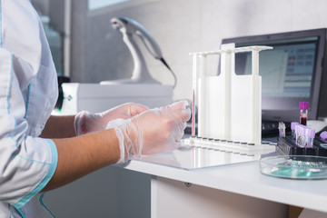Medical clinic. Nurse at her workplace working with blood sample