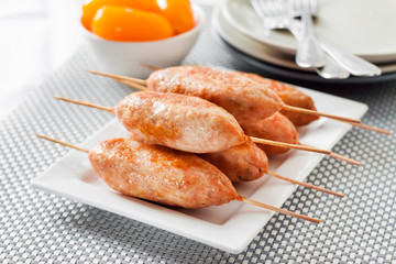 Minced turkey kebabs on square white plate