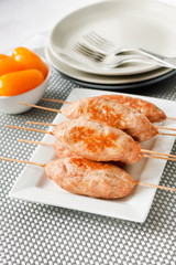 Minced turkey kebabs on square white plate