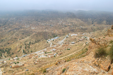 Fototapeta na wymiar Mountain village in the fog. View of the town from above. Tunisia