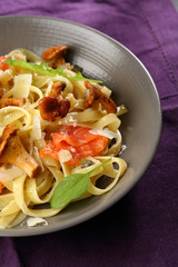 Tasty pasta with salted salmon and chanterelles mushrooms