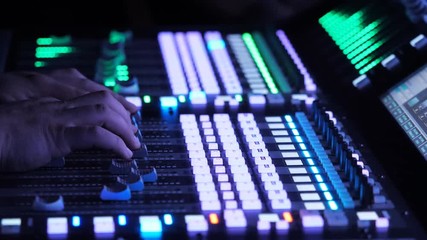 Sound engineer mixing music in studio