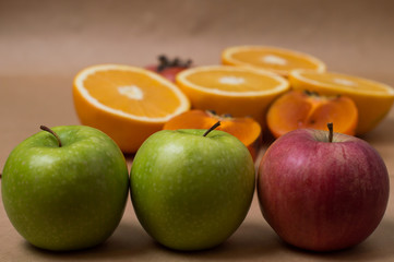 apples and oranges on wooden table