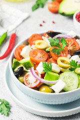 Avocado feta Greek salad in a bowl. Selective focus, space for text.