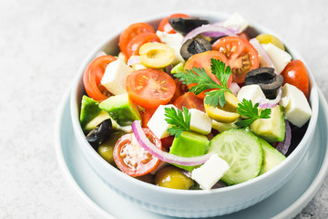 Avocado feta Greek salad in a bowl. Selective focus,close up, space for text.