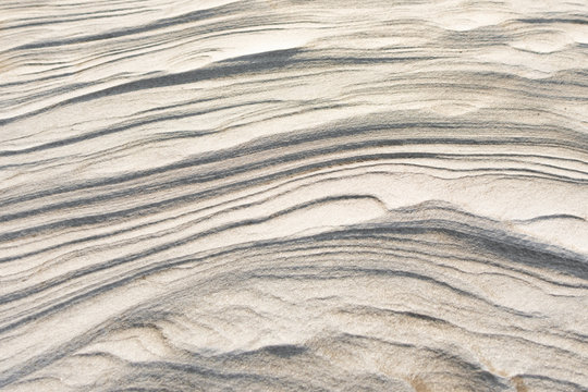 Snow and sand texture. Winter beach background. Snow in desert.