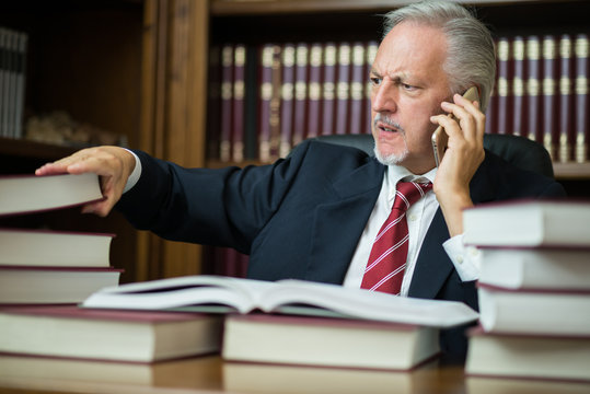 Businessman taking a book while talking on the phone