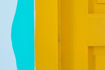 Yellow door and blue wall. Home interior, detail